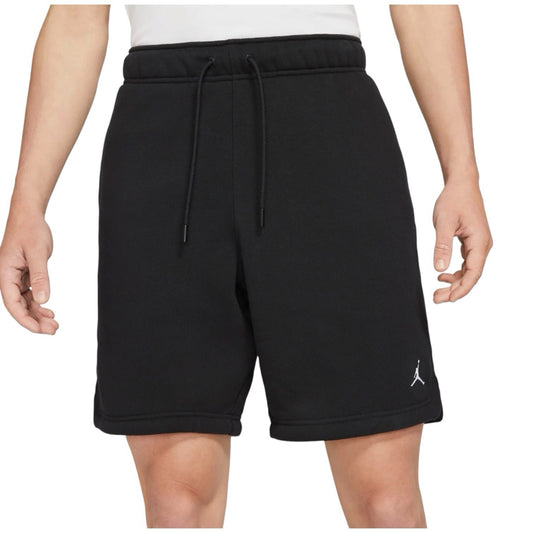 Front view of model wearing black Jordan fleece shorts with drawcord waist