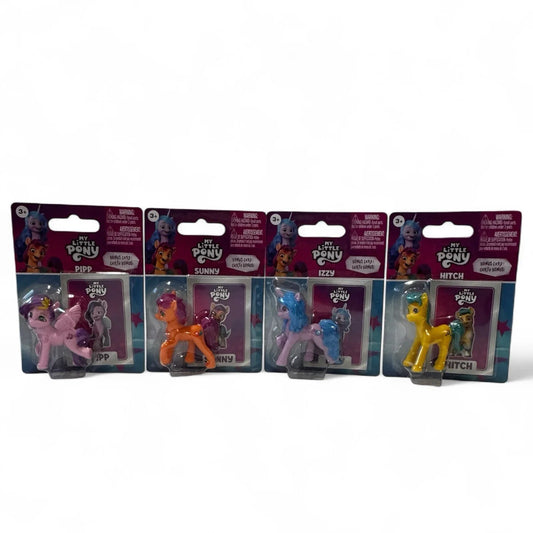 Four My Little Pony mini figures in individual packages with bonus cards